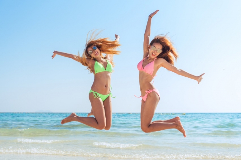 Girls jumping on the beach