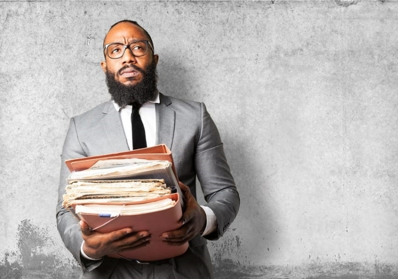 a man carrying folders