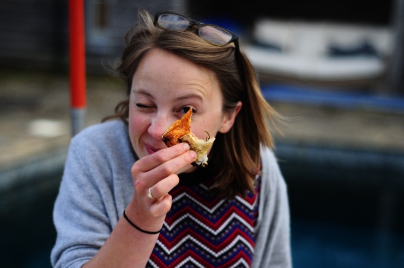Woman eating bread and cheese.