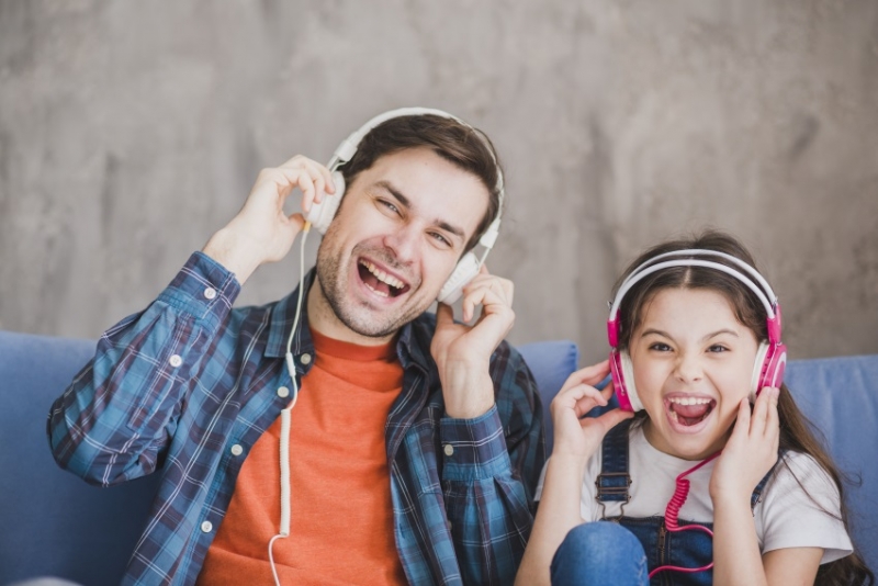 Father and daughter listening to music