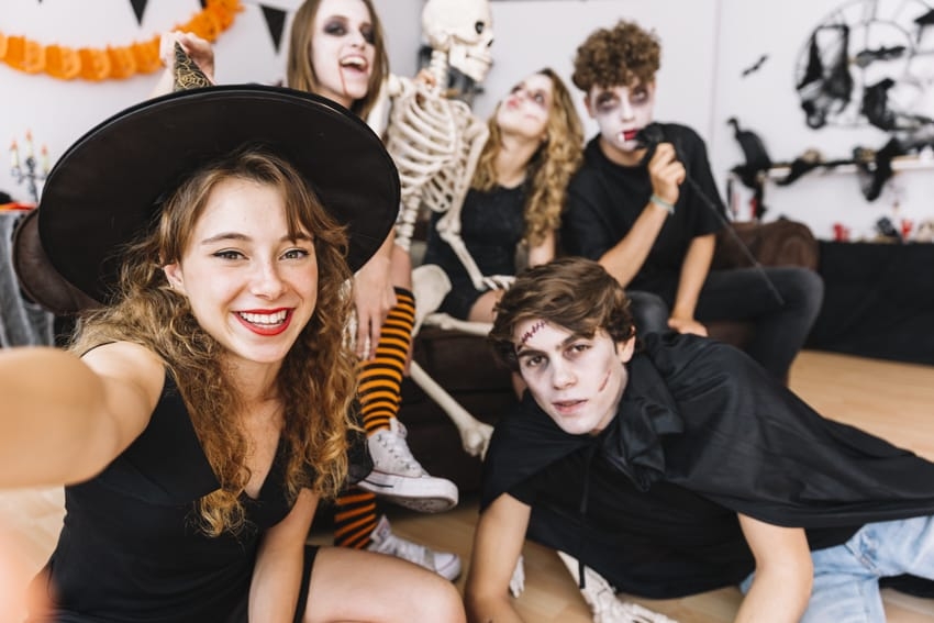 Teenagers taking a selfie in a Halloween party